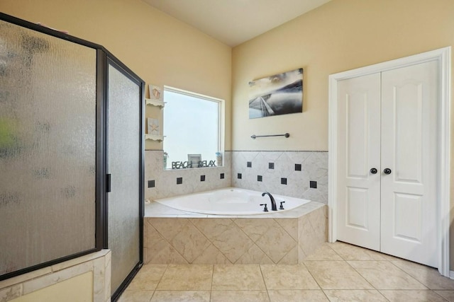 bathroom with separate shower and tub and tile patterned floors