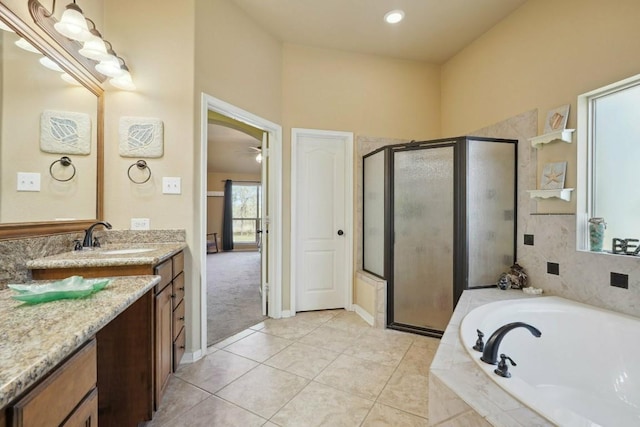 bathroom with tile patterned floors, vanity, ceiling fan, and shower with separate bathtub