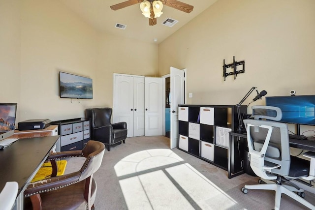 home office with light colored carpet, high vaulted ceiling, and ceiling fan