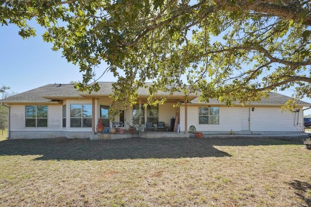 rear view of house with a yard and a patio