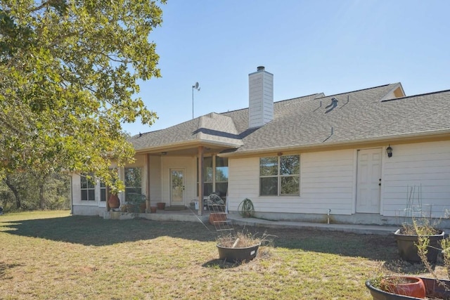 rear view of property featuring a yard