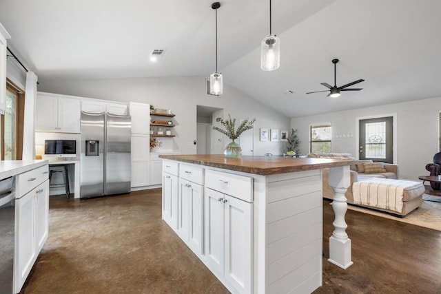 kitchen featuring a kitchen island, white cabinets, vaulted ceiling, and appliances with stainless steel finishes