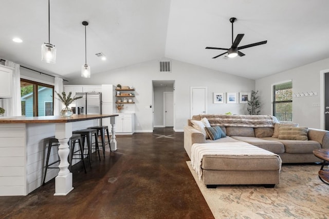 living room featuring ceiling fan and lofted ceiling