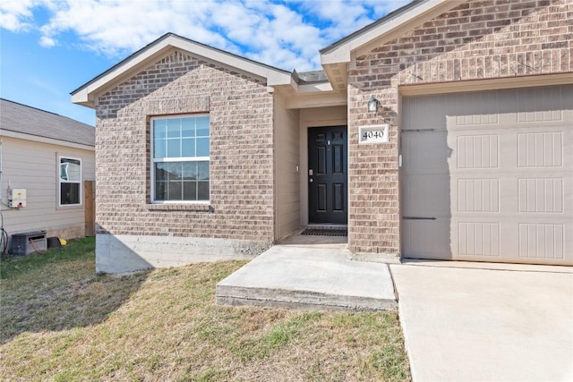 property entrance with a lawn and a garage