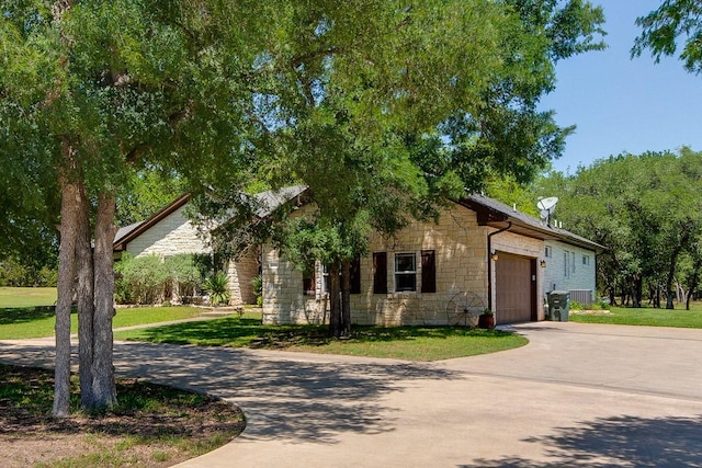 view of front of home with a garage and a front lawn