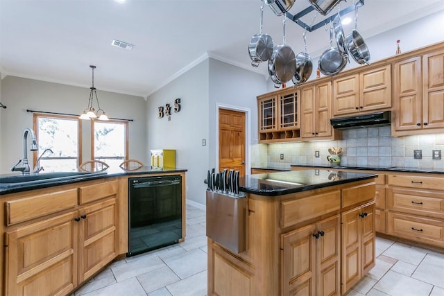 kitchen featuring sink, a center island, hanging light fixtures, decorative backsplash, and black appliances