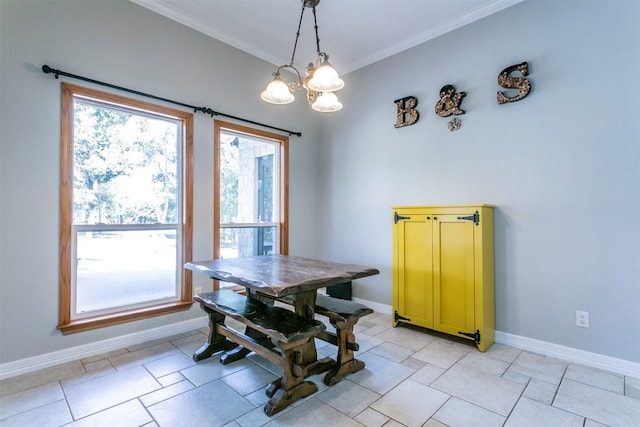 dining area featuring ornamental molding and a chandelier