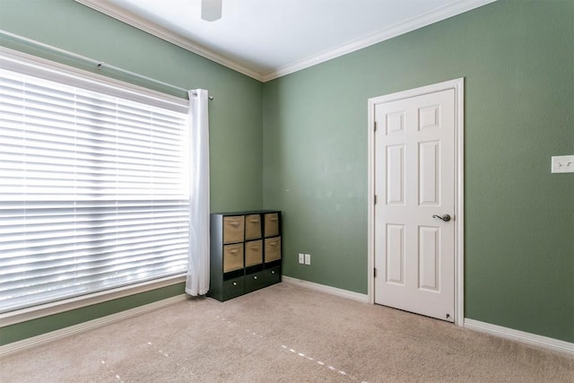 unfurnished bedroom featuring light colored carpet, ceiling fan, and ornamental molding