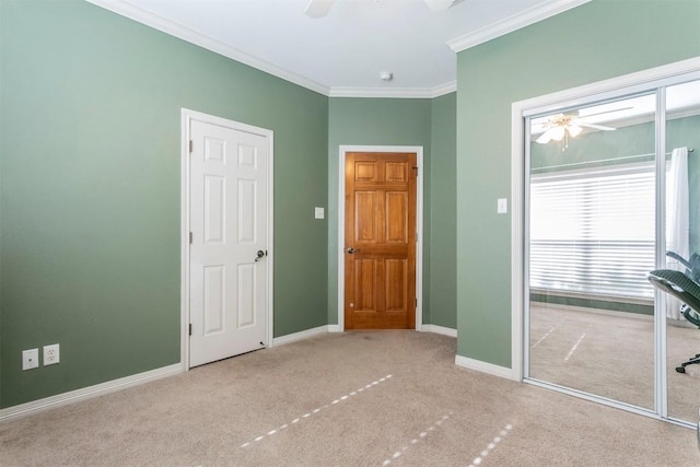 unfurnished bedroom with ceiling fan, crown molding, and light carpet