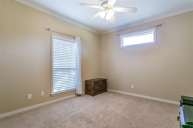 spare room with light carpet, crown molding, and ceiling fan