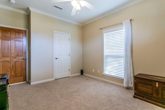 carpeted bedroom with ceiling fan, crown molding, and multiple windows