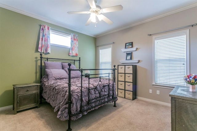 bedroom featuring ceiling fan, light colored carpet, and ornamental molding