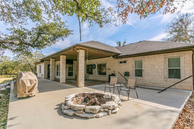 rear view of property with an outdoor fire pit and a patio