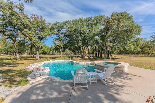 view of swimming pool with a patio area and an in ground hot tub