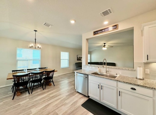 kitchen featuring white cabinetry, dishwasher, sink, and light stone countertops