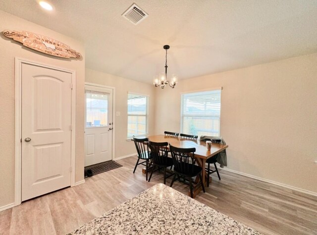 dining area featuring a chandelier and hardwood / wood-style floors