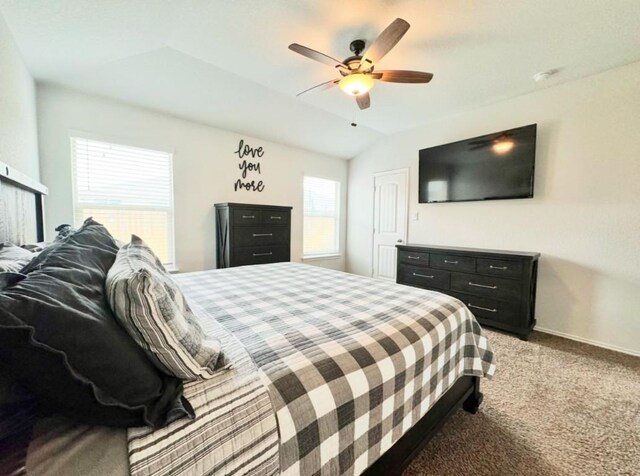 bedroom with vaulted ceiling, carpet flooring, and ceiling fan