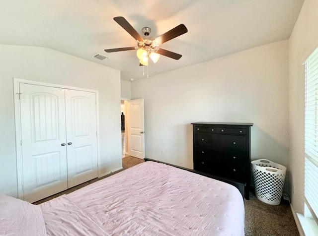 bedroom featuring lofted ceiling, carpet floors, a closet, and ceiling fan