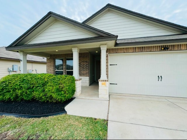 view of front of home featuring a porch and a garage