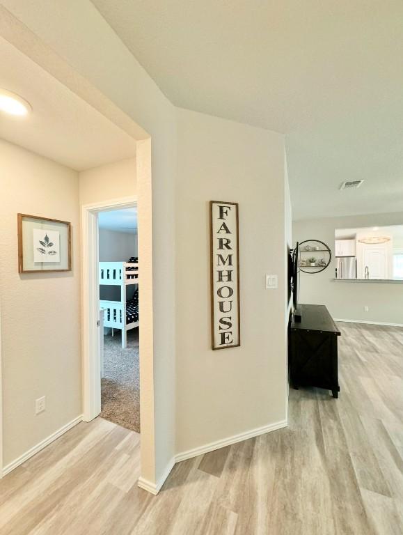 hall with light hardwood / wood-style floors