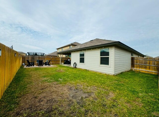 back of house featuring a yard and a patio area