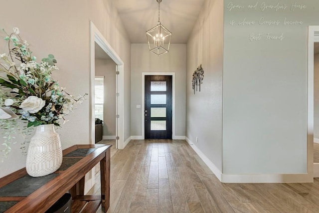 entryway with a chandelier and light wood-type flooring