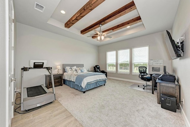 bedroom featuring beam ceiling, light hardwood / wood-style floors, and ceiling fan