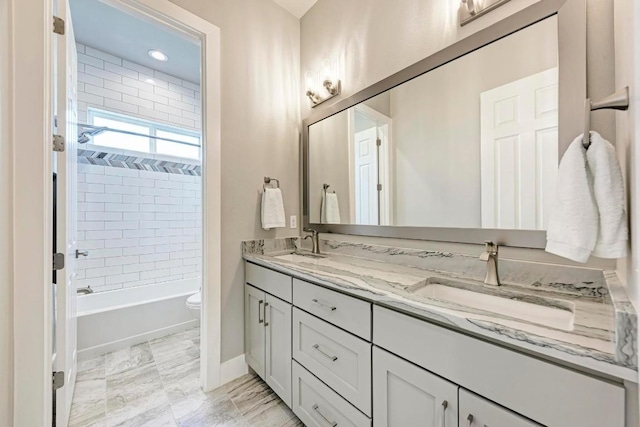 full bathroom featuring vanity, toilet, and tiled shower / bath