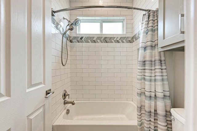 bathroom featuring shower / tub combo with curtain and toilet