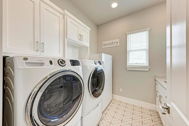 laundry room featuring cabinets and separate washer and dryer