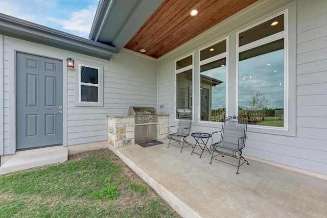 view of patio with area for grilling and exterior kitchen