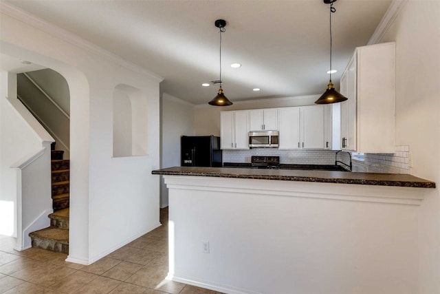 kitchen with backsplash, kitchen peninsula, decorative light fixtures, white cabinets, and black appliances