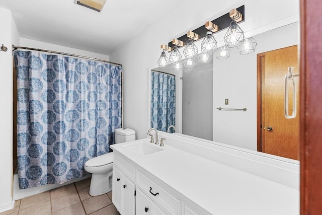 bathroom featuring tile patterned flooring, vanity, and toilet