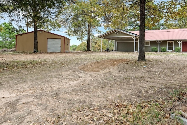 view of yard featuring a garage and a carport