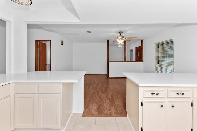 kitchen featuring white cabinetry, kitchen peninsula, ceiling fan, and light hardwood / wood-style floors