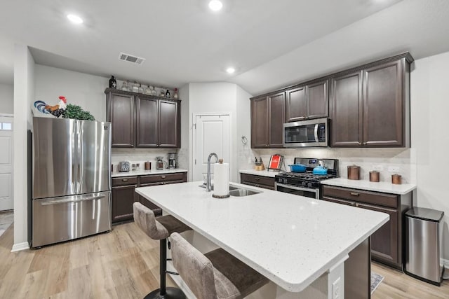 2912 Youngwood St, Leander, TX 78641 - kitchen featuring stainless steel appliances, dark brown cabinets, backsplash, and recessed lighting