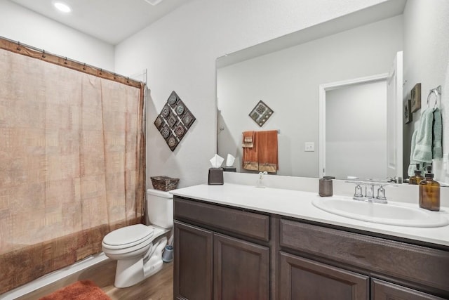 full bathroom with toilet, hardwood / wood-style floors, vanity, and shower / tub combo with curtain