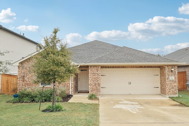 view of front of house with a front yard and a garage