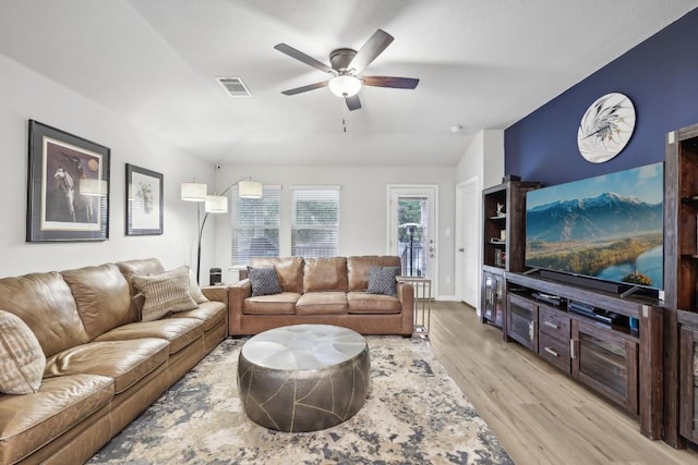 living room with ceiling fan, light hardwood / wood-style flooring, and lofted ceiling