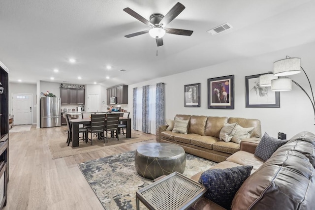 2912 Youngwood St, Leander, TX 78641 - living room with light wood finished floors, a ceiling fan, and recessed lighting