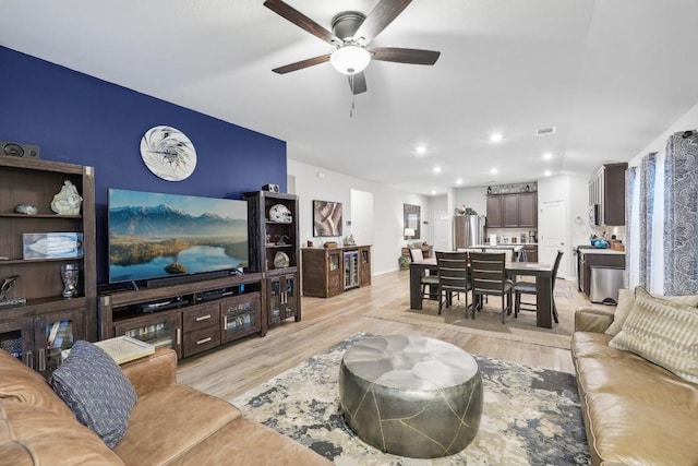 living room featuring ceiling fan and light wood-type flooring