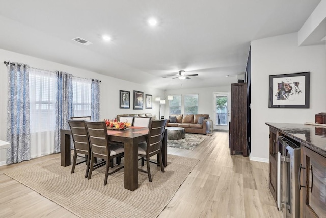 2912 Youngwood St, Leander, TX 78641 - dining space with light wood finished floors, wine cooler, ceiling fan, and recessed lighting