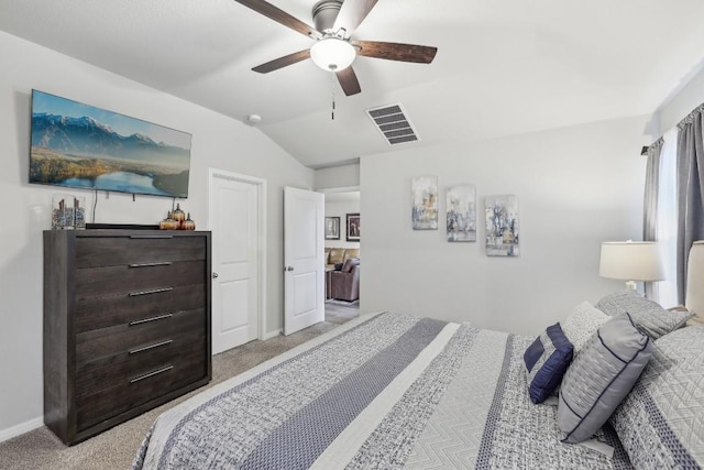 carpeted bedroom with ceiling fan and vaulted ceiling