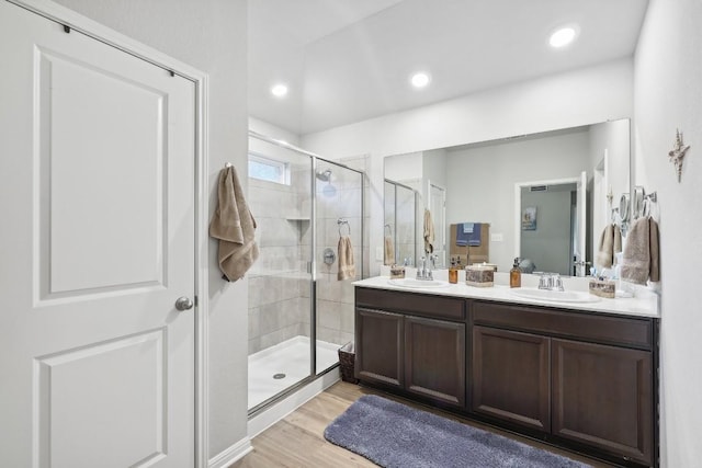 2912 Youngwood St, Leander, TX 78641 - bathroom with double vanity, a stall shower, wood finished floors, and recessed lighting