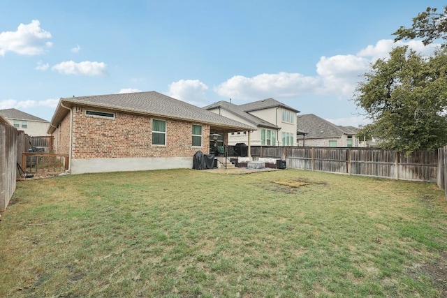 2912 Youngwood St, Leander, TX 78641 - rear view of house featuring brick siding, a fenced backyard, and a patio area