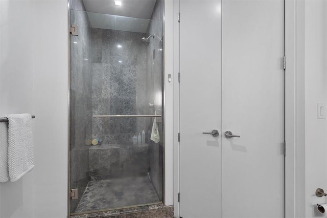 bathroom with a shower with door