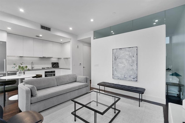 living room with light wood-type flooring and sink