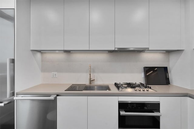 kitchen with white cabinets, sink, and appliances with stainless steel finishes