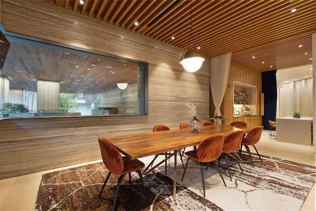 dining area featuring wood walls