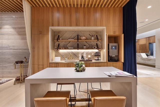 bar featuring wood walls and sink